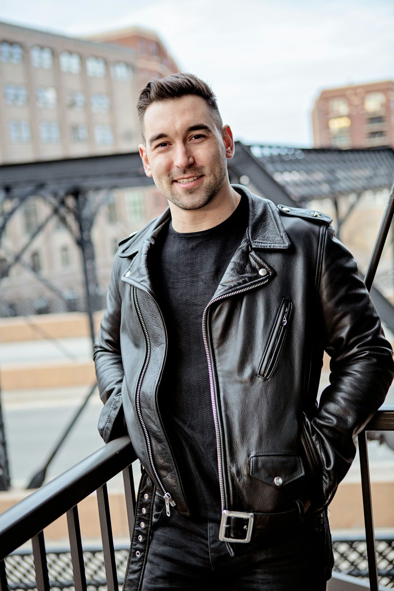 one unknown celebrity standing near black barrier